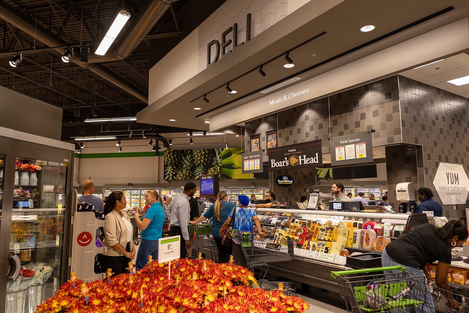 The deli counter at a Publix in Orlando, with shoppers and a Meats & Cheeses sign overhead