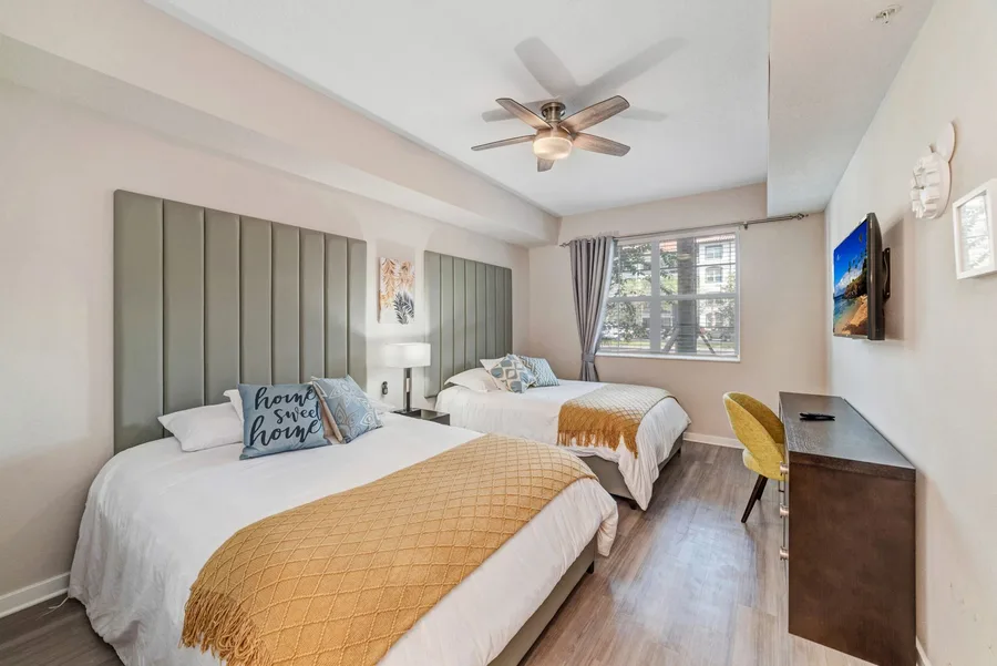 Bedroom with king bed and gold throw